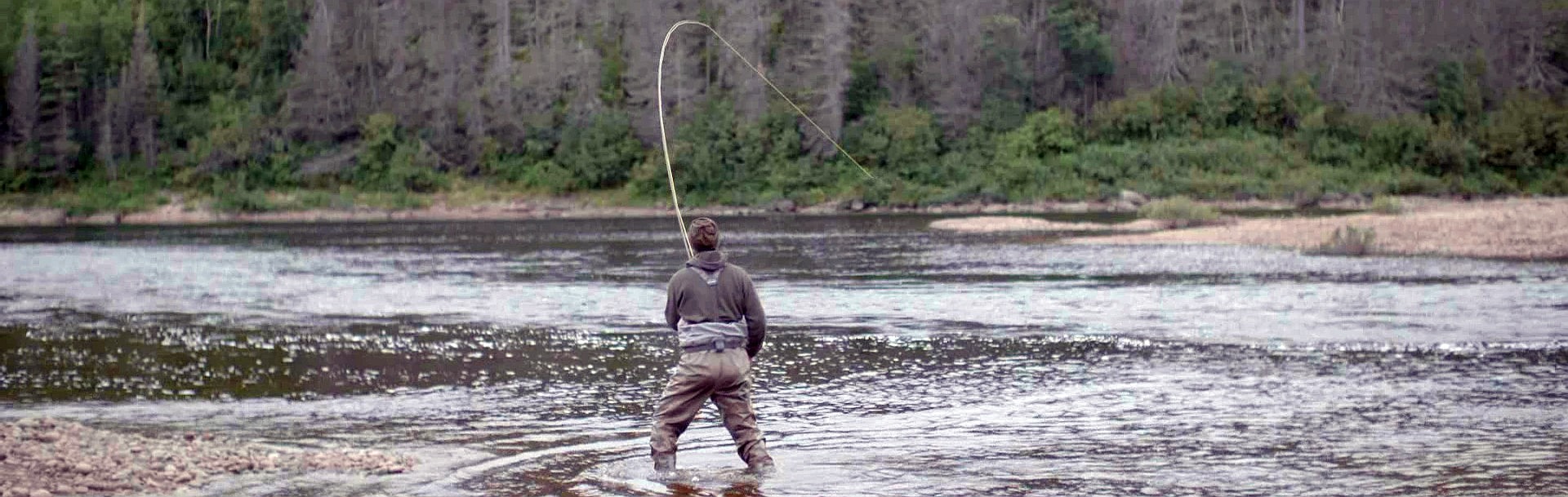A man fighting a salmon