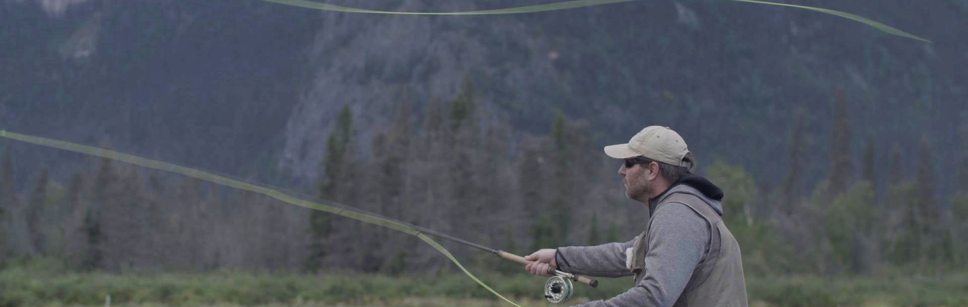 A man casting a fly fishing rod